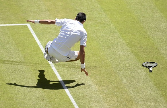 Novak Djokovic of Serbia falls during his match against Richard Gasquet of France at the Wimbledon Tennis Championships in London, July 10, 2015. REUTERS/Andy Rain/Pool