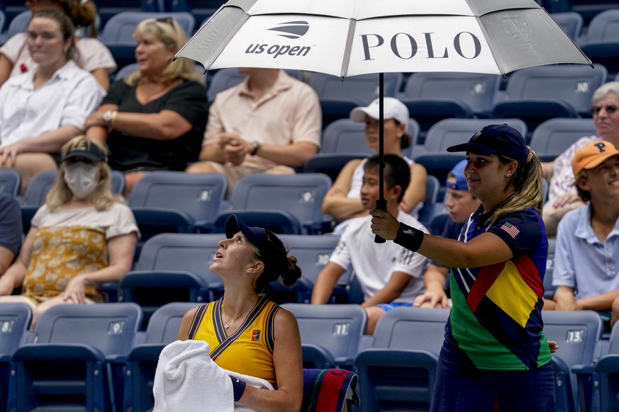 Belinda Bencic, of Switzerland, checks the skies for signs of rain during the first round of the US Open tennis championships against Arantxa Rus, of the Netherlands,, Tuesday, Aug. 31, 2021, in New Y ...