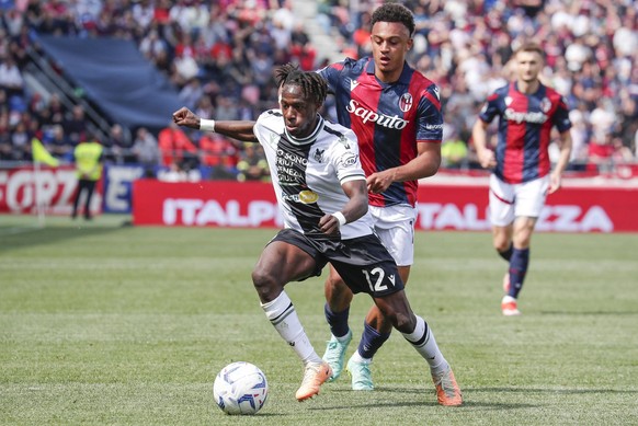 April 28, 2024, Bologna, Italy: Bologna s Dan Ndoye R and Udinese s Hassane Kamara L in action during the Italian Serie A soccer match Bologna FC vs Udinese Calcio at Renato Dall Ara stadium in Bologn ...