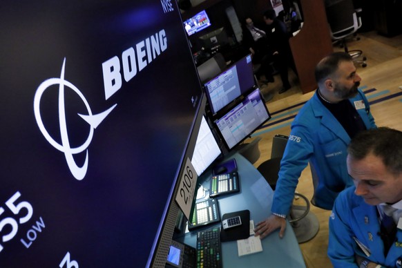 The Boeing logo appears above a trading post on the floor of the New York Stock Exchange, Thursday, March 12, 2020. Boeing stock Boeing Co. closed down $34.24 to $154.84. (AP Photo/Richard Drew)