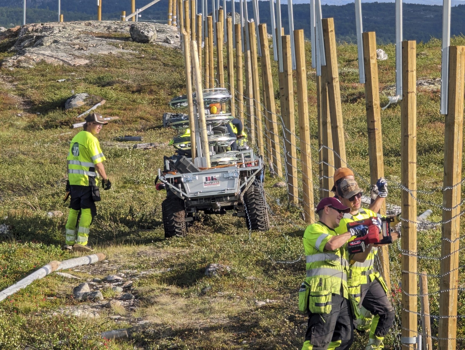 People work to build a new fence along the border with Russia, next to Storskog, Norway, Wednesday Aug. 23, 2023. Norway is re-building a section of fence in the Arctic along its border with Russia to ...