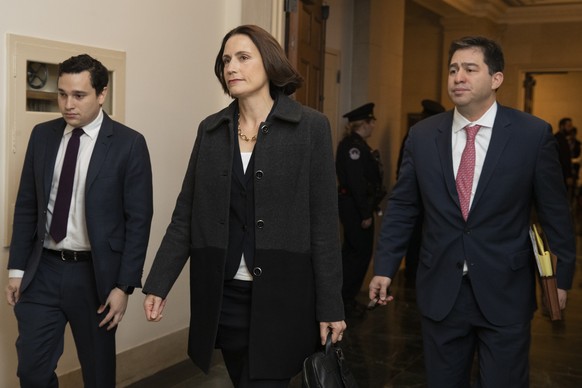 Former White House national security aide Fiona Hill, center, arrives to testify before the House Intelligence Committee on Capitol Hill in Washington, Thursday, Nov. 21, 2019, during a public impeach ...