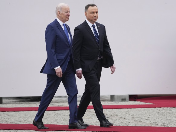 U.S. President Joe Biden, left, and Polish President Andrzej Duda walk during a military welcome ceremony at the Presidential Palace in Warsaw, Poland, on Saturday, March 26, 2022. (AP Photo/Czarek So ...