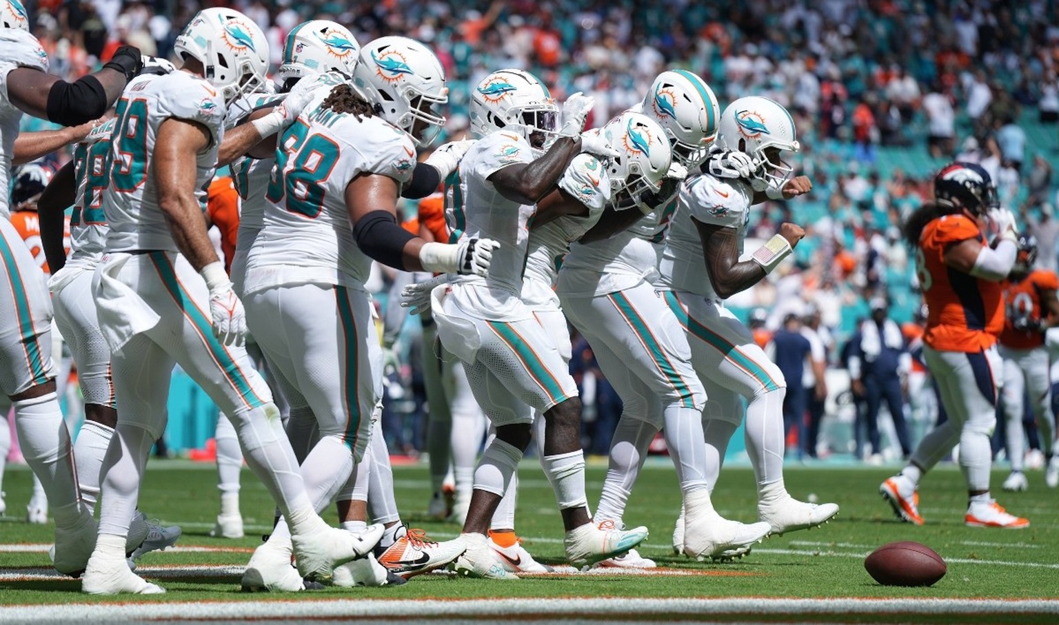 IMAGO / USA TODAY Network

Syndication: Palm Beach Post The Miami Dolphins offense does a dance routine after scoring against the Denver Broncos in the second quarter of an NFL, American Football Herr ...