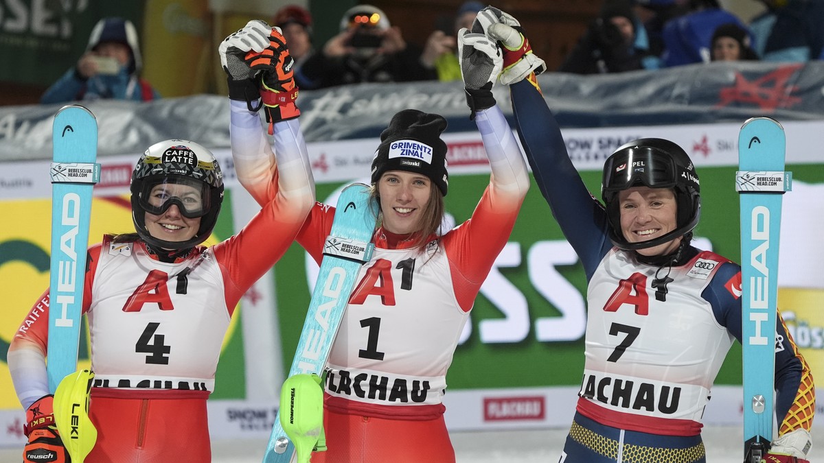 Switzerland's Camille Rast, center, winner of an alpine ski, women's World Cup slalom, poses with second placed Switzerland's Wendy Holdener, left, and third placed Sweden's Sara H ...