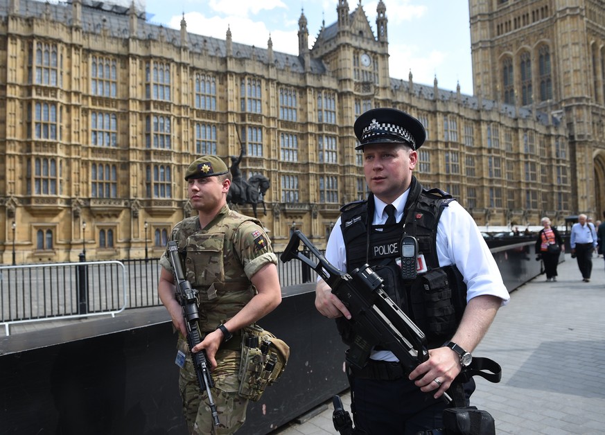 epa05986546 British Army soldiers along with armed police patrol the streets near the Houses of Parliament in London, Britain, 24 May 2017. Britain is on critical alert following the Manchester terror ...