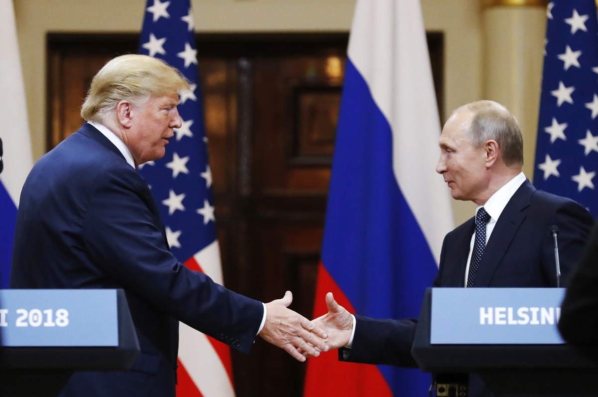 FILE - In this file photo taken on Monday, July 16, 2018, U.S. President Donald Trump shakes hand with Russian President Vladimir Putin at the end of the press conference after their meeting at the Pr ...