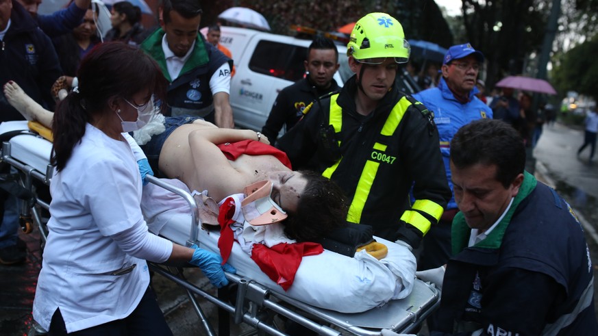 A woman is evacuated on a gurney after an explosion at the Centro Andino shopping center in Bogota, Colombia, Saturday, June 17, 2017. Authorities reported one woman was killed and 11 people injured.  ...