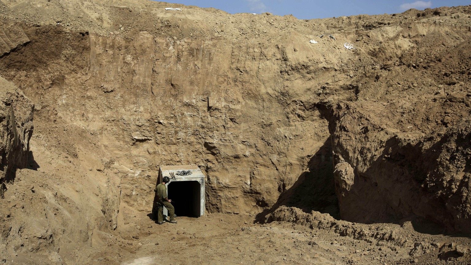 FILE - In this Sunday, Oct. 13, 2013 file photo, an Israeli soldier stands at the exit of a tunnel discovered near the Israel Gaza border. They’ve been dubbed “lower Gaza,” compared to the Underground ...