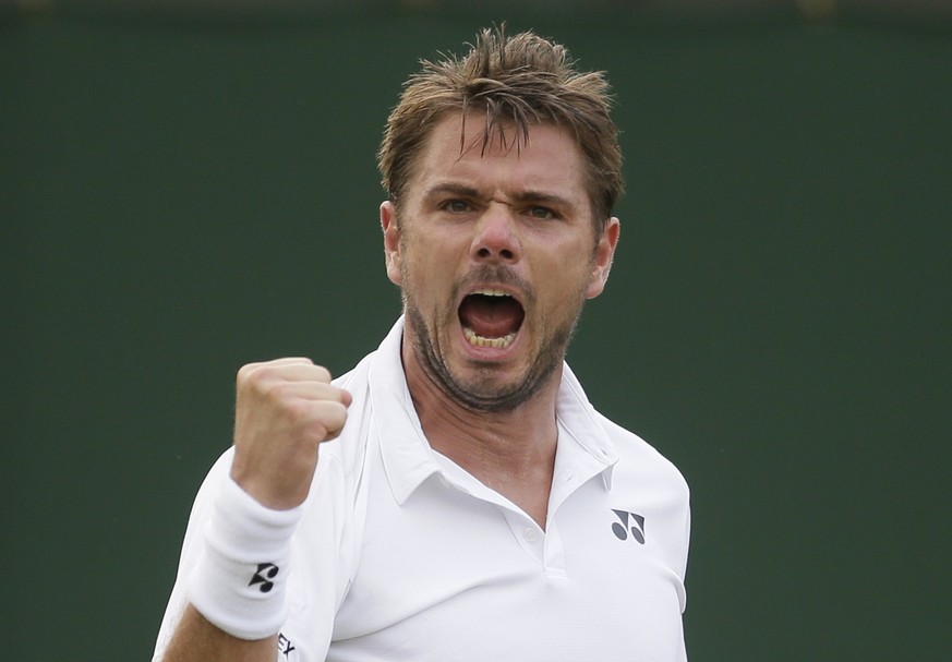 Stan Wawrinka of Switzerland celebrates breaking the serve of Thomas Fabbiano of Italy during their men&#039;s singles match on the third day at the Wimbledon Tennis Championships in London, Wednesday ...