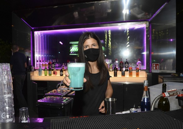 epa08538427 A bartender prepares a drink at &#039;Old Fashion&#039;, a famous restaurant and nightclub in Milan, northern Italy, early 10 July 2020. Clubs, which have been closed due to the lockdown o ...