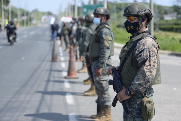 epa09034698 Soldiers guard the Zonal 8 Deprivation of Liberty Center, one of the four Ecuadorian prisons where riots took place a day earlier, in Guayaquil, Ecuador, 24 February 2021. The number of de ...