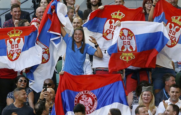 Supporters of Serbia&#039;s Novak Djokovic display Serbian national flags during his final match against Britain&#039;s Andy Murray at the Australian Open tennis tournament at Melbourne Park, Australi ...