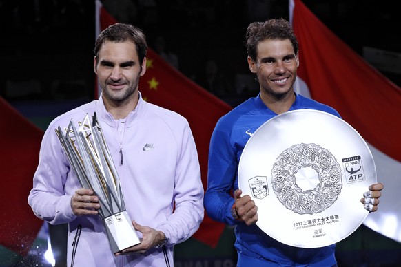 Winner&#039;s Roger Federer of Switzerland, left, holding the winner&#039;s trophy and Rafael Nadal of Spain pose with their trophies after the award ceremony for the Shanghai Masters tennis tournamen ...
