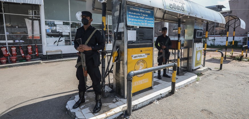 epaselect epa10038134 Armed Sri Lankan military personnel stand guard at a closed gas station amid a fuel shortage in Colombo, Sri Lanka, 28 June 2022. Sri Lankan government suspended nationwide fuel  ...