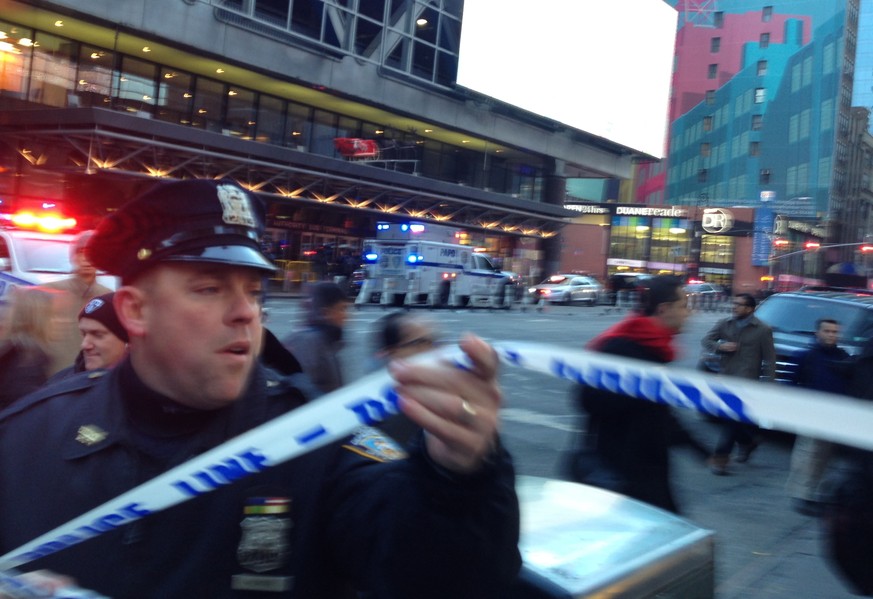 Police respond to a report of an explosion near Times Square on Monday, Dec. 11, 2017, in New York. (AP Photo/Charles Zoeller)