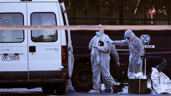 Forensics experts search for evidence outside the French Embassy, where unidentified attackers threw an explosive device which caused a small blast, in Athens, Greece, November 10, 2016. REUTERS/Alkis ...