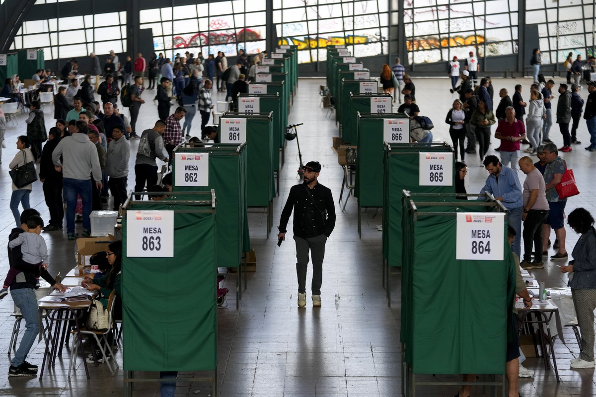 Voters line up at a polling station in Santiago, Chile, Sunday, Dec. 17, 2023. For the second time in as many years, Chileans vote in a referendum on whether to replace the current constitution which  ...