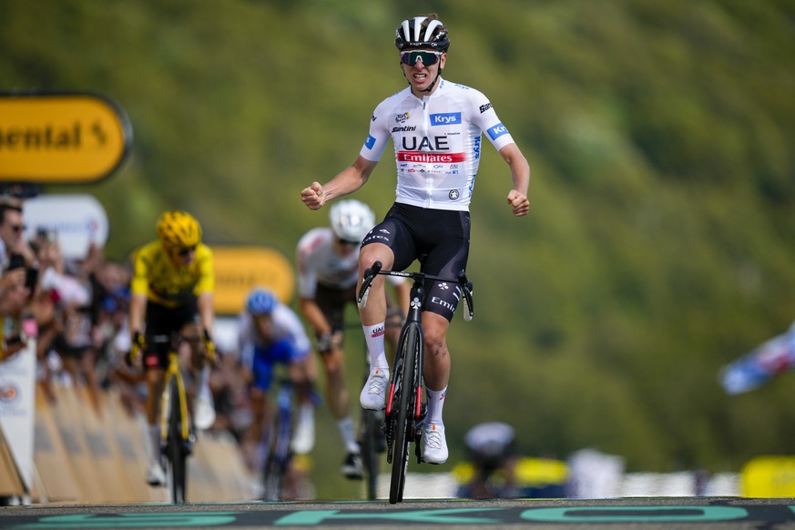 Slovenia&#039;s Tadej Pogacar, wearing the best young rider&#039;s white jersey, celebrates as he crosses the finish line ahead of Denmark&#039;s Jonas Vingegaard, left, and Austria&#039;s Felix Gall  ...