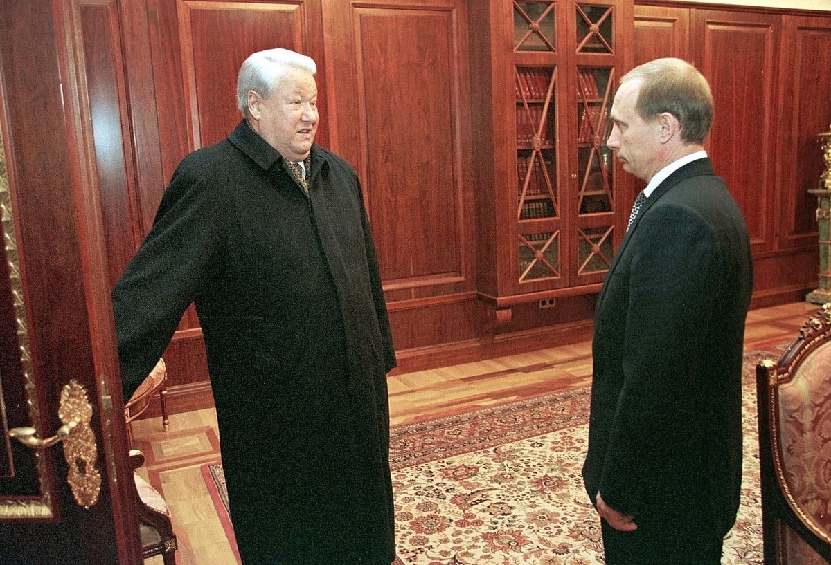 FILE - In this file photo taken on Friday, Dec. 31, 1999, former President Boris Yeltsin smiles as he holds a door before leaving his study as his successor, Vladimir Putin, listens in the Kremlin, in ...