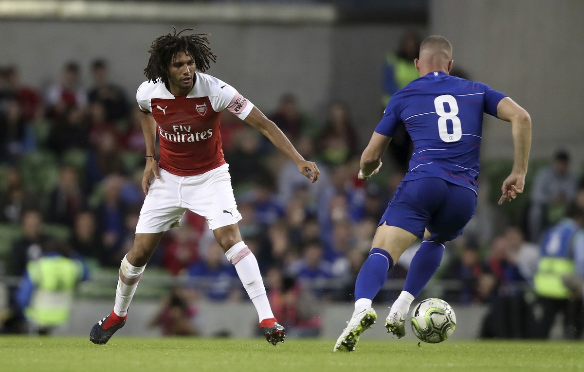 Arsenal's Mohamed Elneny, left, and Chelsea's Ross Barkley battle for the ball during the pre-season friendly soccer match at the Aviva Stadium, Dublin, Wednesday Aug. 1, 2018. (Niall Carson ...