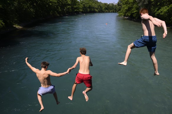epa10080242 People jump from a bridge into the Aare River during the sunny and warm weather, in Bern, Switzerland, 19 July 2022. EPA/ANTHONY ANEX