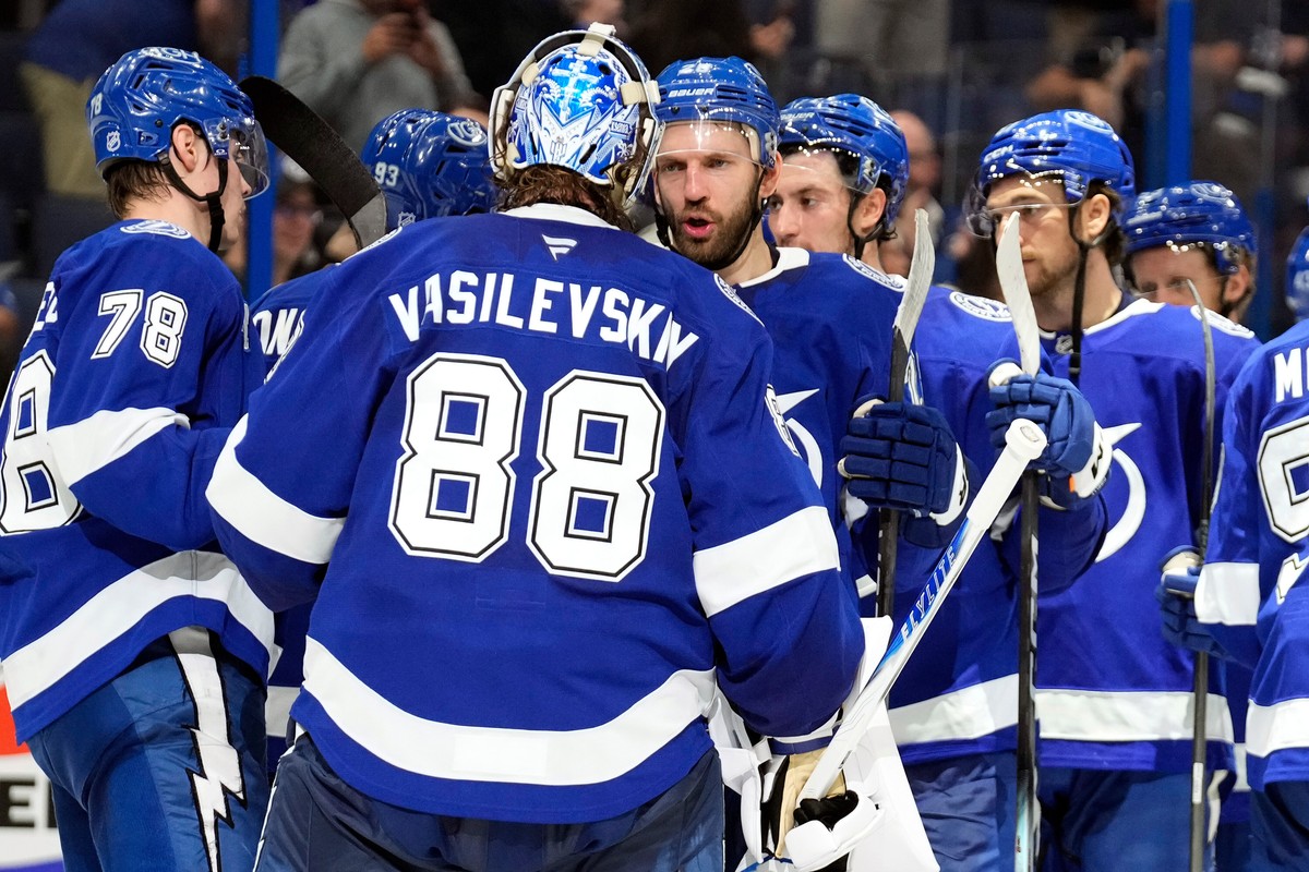 Tampa Bay Lightning goaltender Andrei Vasilevskiy (88) celebrates with teammates after defeating the New Jersey Devils in an NHL hockey game Tuesday, Nov. 18, 2025, in Tampa, Fla. (AP Photo/Chris O  ...