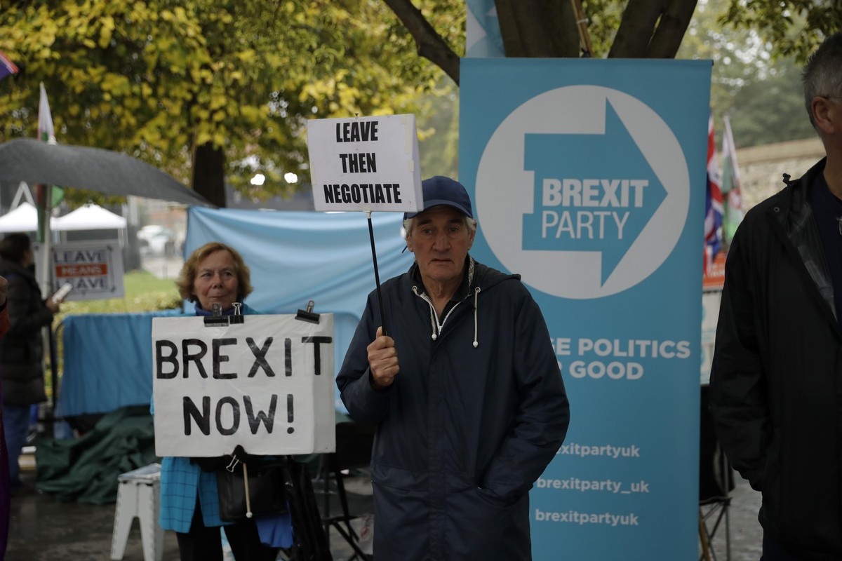 Pro-Brexit leave the European Union supporters hold placards opposite the Houses of Parliament in London, Thursday, Oct. 24, 2019. Britain's Prime Minister Boris Johnson won Parliament's bac ...