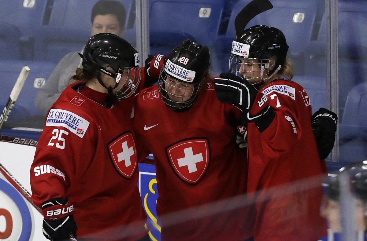 Switzerland forwards Alina Muller (25), Rahel Enzler (28) and Lara Stalder celebrate after Muller's goal during the first period of a IIHF Women's World Championship hockey tournament game a ...