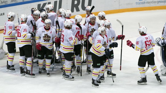 Kunlun Red Star's team players celebrate after they won the Kontinental Hockey League match against Spartak Moscow, in Moscow, Russia, Saturday, Oct. 1, 2016. (AP Photo/Pavel Golovkin)