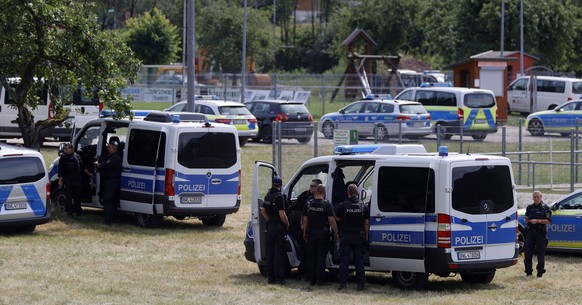 epa08545587 German police cars stand for searching for a man armed with knives and pistols in a forest area north of Oppenau near Offenburg, Germany, 14 July 2020. According to the police, the suspect ...