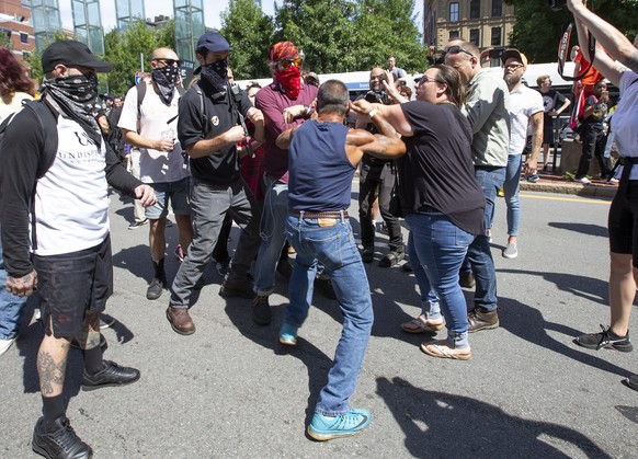 epa07808439 Protesters fight with a participant (C) of the &#039;Straight Pride Parade&#039; on Congress Street in Boston, Massachusetts, USA, 31 August 2019. Despite outrage from local politicians in ...