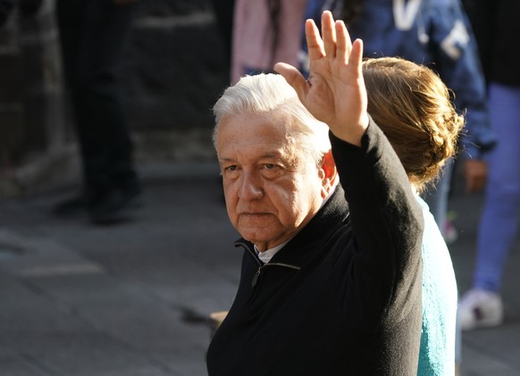 Mexico� ?s President Andres Manuel Lopez Obrador walks with his wife Beatriz Gutierrez Muller, before voting in a national referendum on whether he should end his six-year term barely midway through o ...