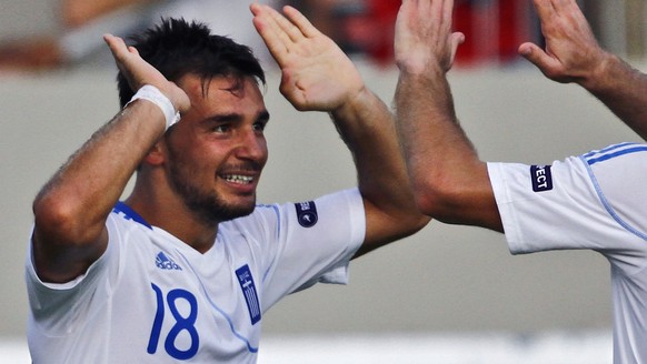 Greece&#039;s Sotiris Ninis, left, celebrates a goal with Greece&#039;s Dimitris Salpingidis during their Group F EURO 2012 qualifying soccer match against Israel in the Bloomfield stadium in Tel Aviv ...