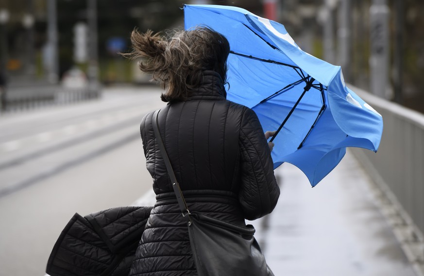 A woman with an umbrella in the wind during the storm Ciara in Bern, Switzerland, Monday, February 10, 2020. Western and northern Europe braces for storm Ciara that is expected to bring strong winds a ...