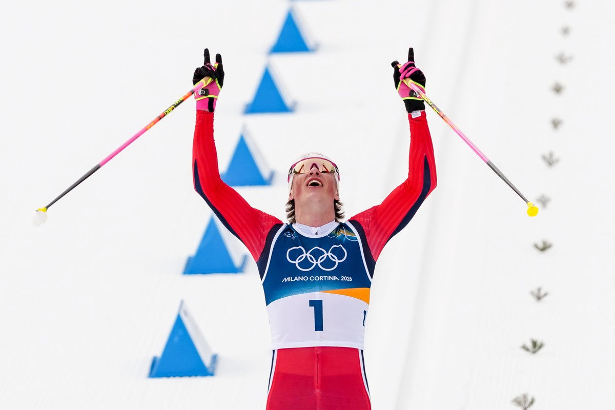 Johannes Hoesflot Klaebo, of Norway, crosses the finish line to win the gold medal during the cross country skiing men's 50km mass start Classic at the 2026 Winter Olympics, in Tesero, Italy, Sat ...