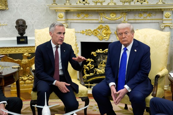 FILE - Canada Prime Minister Mark Carney and President Donald Trump hold a press conference at the White House in Washington, D.C., Oct. 7, 2025. (Adrian Wyld/The Canadian Press via AP, File)
Mark Car ...