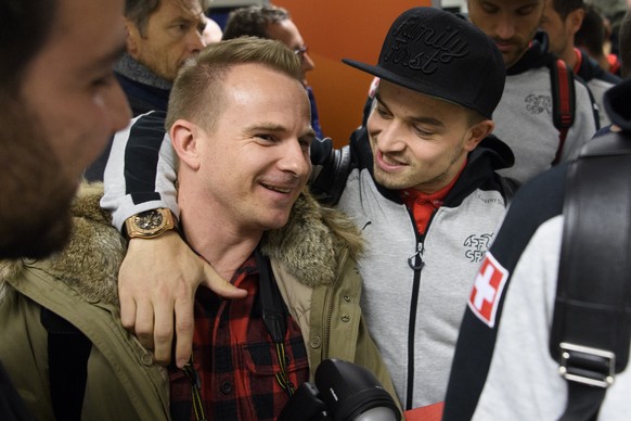 Swiss soccer national team player Xherdan Shaqiri, right, jokes with Blick photographer Toto Marti, left, before boarding at Belfast Airport two days before the 2018 Fifa World Cup play-offs second le ...
