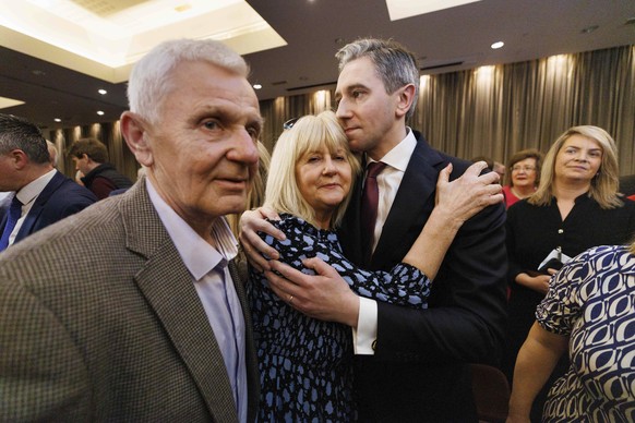 Simon Harris reacts with his parents Mary and Bart, after he was confirmed as the new leader of Fine Gael, paving the way for him to become Ireland&#039;s youngest premier, in Athlone, Ireland, Sunday ...