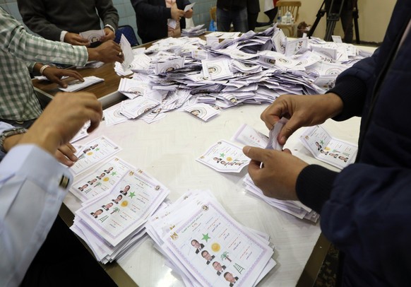 epa11025140 Egyptian electoral workers count ballots at the end of the last day of the Egyptian presidential elections in Cairo, Egypt, 12 December 2023. Egyptians continued to head to polls on the la ...