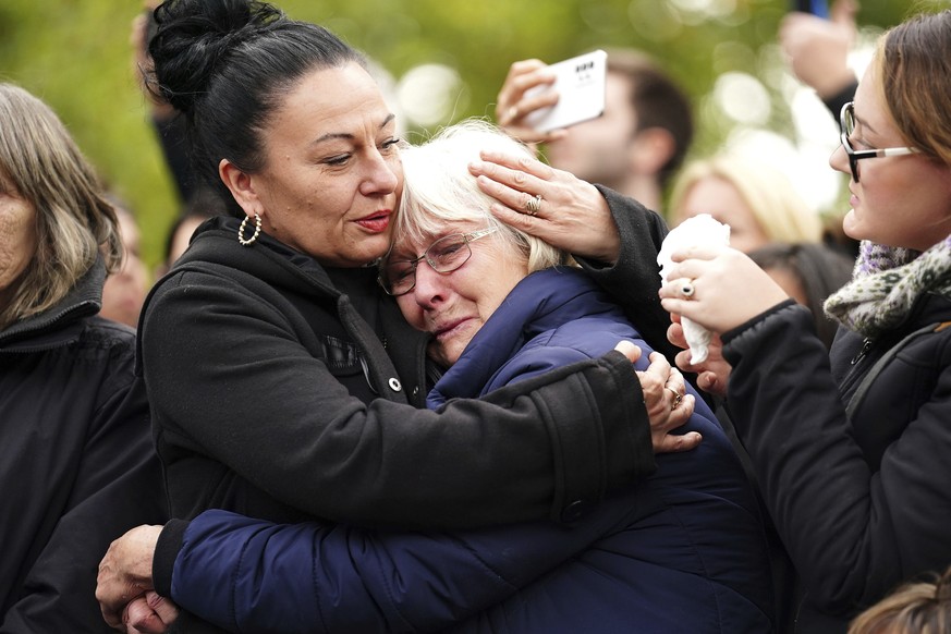 People react as the State Gun Carriage carrying the coffin of Queen Elizabeth II passes by during the Ceremonial Procession following her State Funeral at Westminster Abbey, London, Monday, Sept. 19,  ...