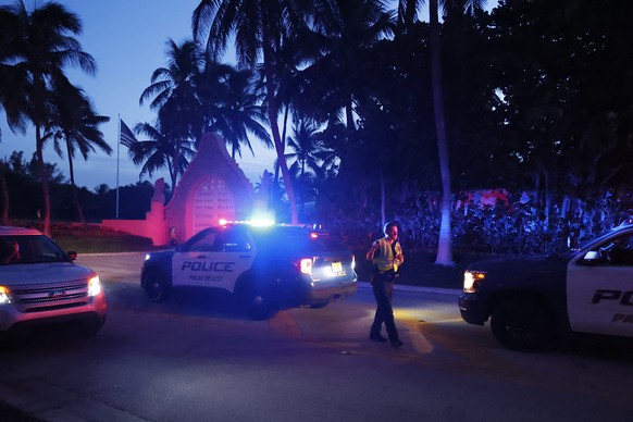 Police direct traffic outside an entrance to former President Donald Trump&#039;s Mar-a-Lago estate, Monday, Aug. 8, 2022, in Palm Beach, Fla. Trump said in a lengthy statement that the FBI was conduc ...