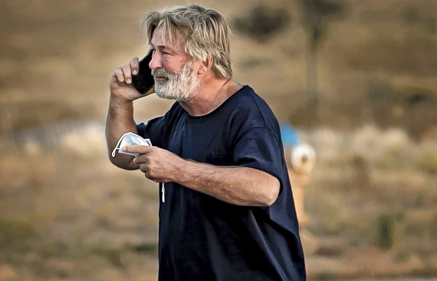 Alec Baldwin speaks on the phone in the parking lot outside the Santa Fe County Sheriff&#039;s Office in Santa Fe, N.M., after he was questioned about a shooting on the set of the film &quot;Rust&quot ...