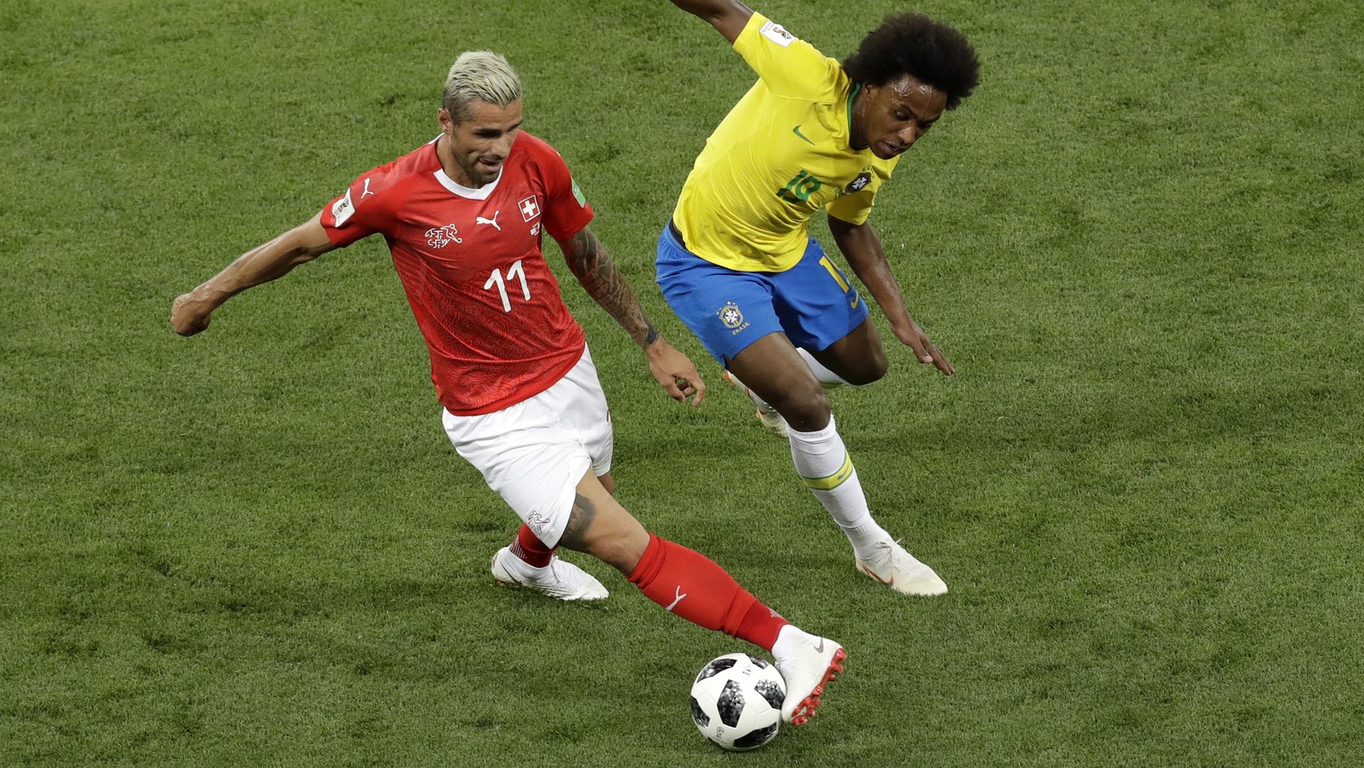 Switzerland&#039;s Valon Behrami, left, controls the ball as Brazil&#039;s Willian tries to stop him during the group E match between Brazil and Switzerland at the 2018 soccer World Cup in the Rostov  ...