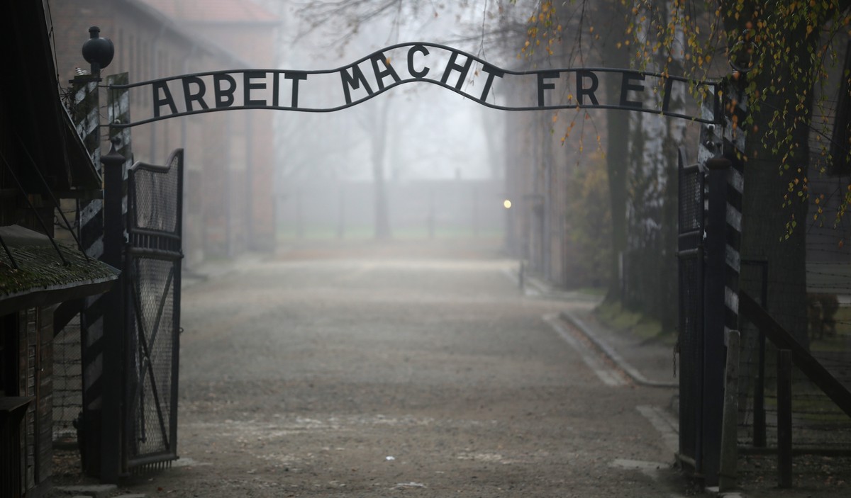 OSWIECIM, POLAND - NOVEMBER 15: The infamous German inscription that reads 'Work Makes Free' at the main gate of the Auschwitz I extermination camp on November 15, 2014 in Oswiecim, Poland.  ...