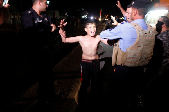 Iraqi security forces detain a boy after removing a suicide vest from him in Kirkuk, Iraq, August 21, 2016. REUTERS/Ako Rasheed