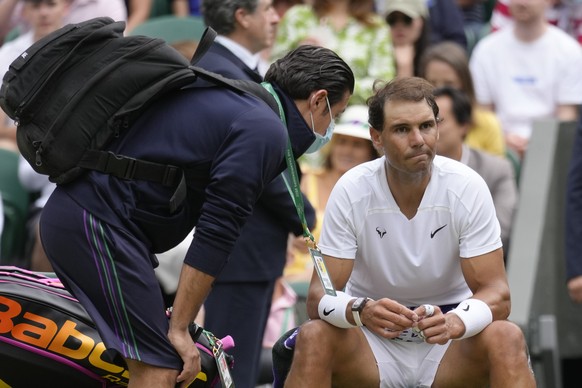 FILE - Spain&#039;s Rafael Nadal receives treatment just before a medical timeout as he plays Taylor Fritz of the US in a men&#039;s singles quarterfinal match on day ten of the Wimbledon tennis champ ...