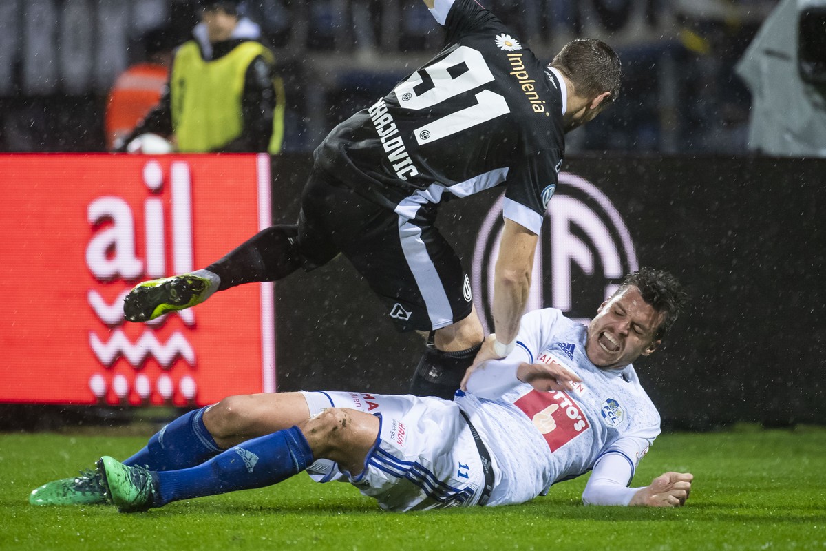 From left, Lugano's player Dragan Mihajlovic and LuzernÄôs player Pascal Schuerpf, during the Super League soccer match between FC Lugano and FC Luzern, at the Cornaredo stadium in Lugano, Satur ...