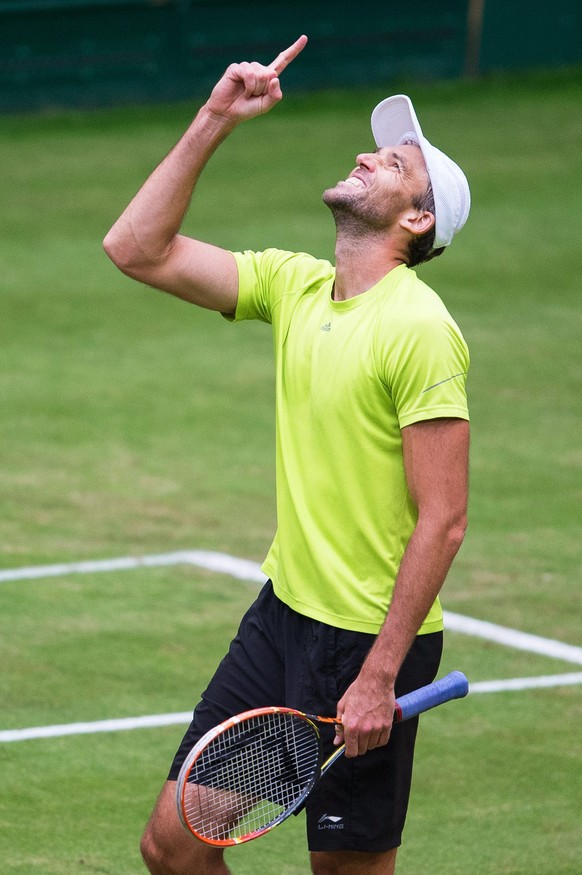 epa04808564 Ivo Karlovic of Croatia celebrates after beating Tomas Berdych of the Czech Republic in their quarter final match at the ATPÂ tennis tournament in Halle, Germany, 19 June 2015. EPA/MAJAÂ H ...