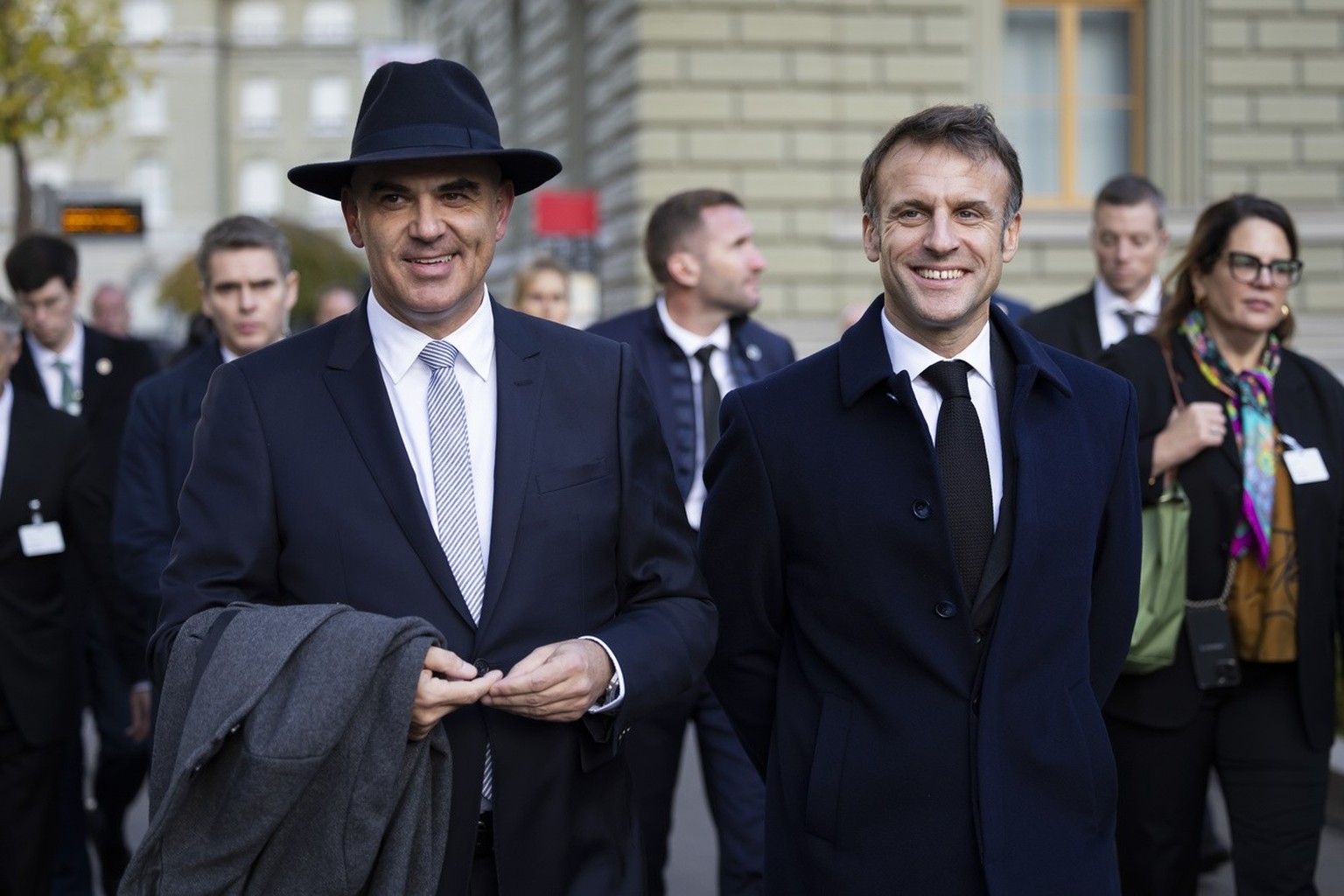 Swiss Federal President Alain Berset, left, and French President Emanuel Macron discuss on their way to the delegation meeting in front of the Federal Palace, the Swiss Parliament building, in Bern, S ...
